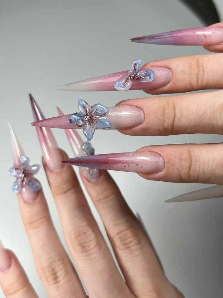 Purple gradient stiletto nails with sculpted 3D clear floral petals